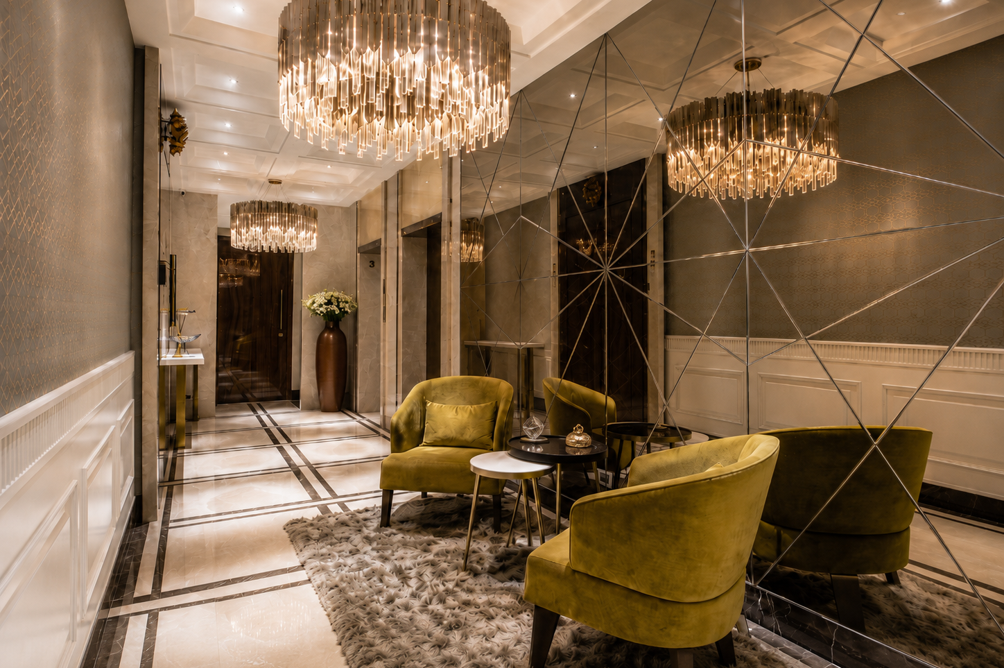Satra Residence foyer with mirrored walls, marble flooring, velvet seating and statement chandeliers
